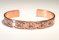 a copper bracelet with designs on it