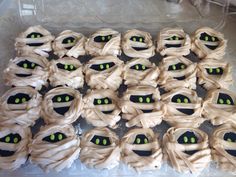 there are many cupcakes with green eyes in the shape of monster's mouths