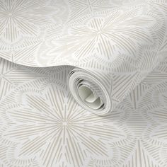 a white wallpaper with an intricate design on it's side and the top part of the wall