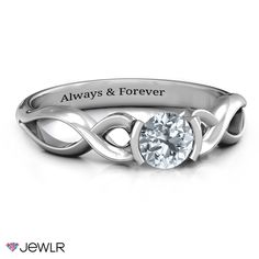 a white gold ring with an engraved message on the side and a round diamond in the center