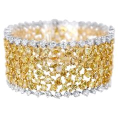 Jay Feder 18k Two Tone Gold Fancy Yellow Diamond and White Diamond Bracelet Set with White and Fancy Yellow Mixed shaped diamonds; estimated total weight is 43.15ctw. The bracelet is 7 inches long; links are 1.25 inches wide. The total weight of the bracelet is 51.4 grams. Good condition, minor evidence of wear, some tiny scratches to the metal. Cleaned and ready to wear. All Returns and exchanges must be authorized by the seller within 3 days of delivery. Merchandize may be returned for exchang Katherine Howard, Two Tone Bracelet, Fancy Yellow Diamond, Expensive Jewelry, Yellow Fashion, Diamond Bracelets, Yellow Diamond, White Diamond, Diamond White