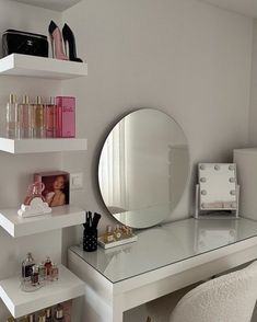 a white desk with a mirror and some shelves