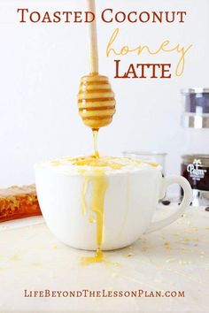 a cup filled with honey and drizzled with the words toasted coconut honey latte