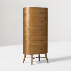 a tall wooden cabinet sitting on top of a white floor