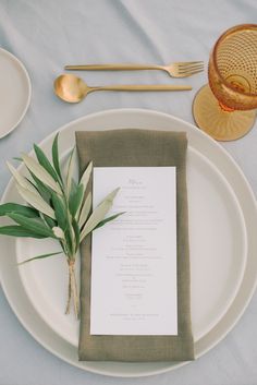 a table setting with place settings, silverware and napkins on it is shown