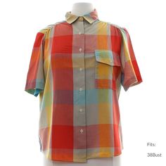 "80s \"rrrruss\" Womens multi color background polyester cotton blend short sleeve button up front shirt. Blocked plaid in shades of red, turquoise, gold, and hazy orange, red and grey, ruched shoulders. Fold over collar, single flap pocket with button closure and slightly rounded hemline. Fits: 38Bust Our item # 362914" Summer Plaid Button-up Short Sleeve Shirt, Retro Multicolor Short Sleeve Shirt For Spring, Retro Multicolor Cotton Camp Shirt, Retro Multicolor Short Sleeve Camp Shirt, Vintage Multicolor Short Sleeve Shirt For Summer, Retro Multicolor Relaxed Fit Shirt, Summer Plaid Short Sleeve Camp Shirt, Plaid Relaxed Fit Camp Shirt For Summer, Relaxed Fit Plaid Camp Shirt For Summer