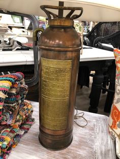 an old fashioned fire extinguisher sitting on top of a table