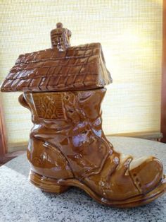 a brown boot sitting on top of a counter next to a window