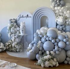 balloons, flowers and candles are arranged on the table for a wedding reception in blue and white