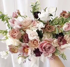 a vase filled with lots of different colored flowers