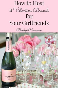 wine glasses and champagne bottles on a table with pink roses in the background text reads how to host a valentine's brunch for your girlfriends