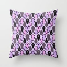 a purple and black pillow with an abstract design on the front, featuring hexagonal shapes