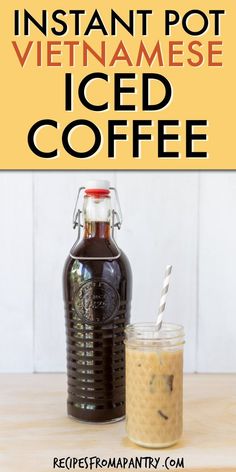 an iced coffee in a glass next to a bottle