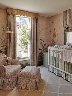 a baby's room with floral wallpaper and furniture