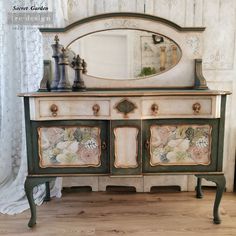 an old dresser has been painted with flowers and leaves on the side, along with a mirror