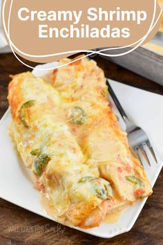 creamy shrimp enchiladas on a white plate with a fork