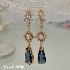 Elevate your elegance with our gold-plated Art Deco earrings: a combination of timeless sophistication and contemporary charm. The navy blue teardrop-shaped crystals hang gracefully, creating a fascinating play of light that is sure to catch everyone's eye. Something Blue takes on a whole new meaning with these earrings, making them the perfect choice for brides looking to incorporate a touch of tradition and style. The earrings provide comfort without compromising glamour, ensuring you shine al Elegant Sapphire Teardrop Earrings, Blue Sapphire Jewelry, Shaped Crystals, Blue Stud Earrings, Art Deco Gold, Crystal Teardrop Earrings, Earrings Making, Deco Earrings, Etsy Bridesmaid Gifts