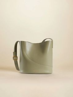 Nova Bucket Sage Soft Elegant Green Large Capacity Bucket Bag, Elegant Green Bucket Bag With Large Capacity, Chic Bucket Shoulder Bag With Adjustable Strap, Chic Travel Bucket Shoulder Bag, Elegant Green Bucket Bag With Adjustable Strap, Chic Green Bucket Bag, Chic Rectangular Bucket Bag For Errands, Modern Bucket Bag With Removable Pouch For Errands, Elegant Tote Bucket Bag For Errands