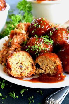 meatballs and rice on a plate with garnish