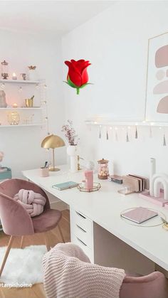 a white desk topped with lots of pink furniture