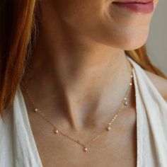 5 sweet little freshwater pearls beautifully anchored on our favorite chain. A classic and simple necklace to wear alone or layer. DETAILSAvailable in 14k Gold Fill or Sterling SilverChoose from 14", 16" or 18” lengths with 1" extender for the clasp.Hypoallergenic and water-proof Simple Bridal Necklace, Pearl Gold Necklace, Gold Bridal Necklace, Bridal Pearl Necklace, Gold Pearl Necklace, Bridal Pearls, Bridal Necklace, Simple Necklace, Gold Pearl