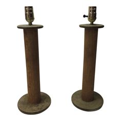 two metal and wood candlesticks on stands