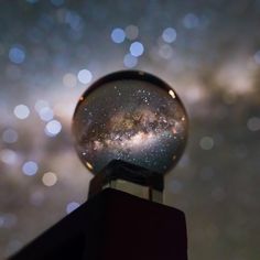 a close up of a snow globe with stars in the background