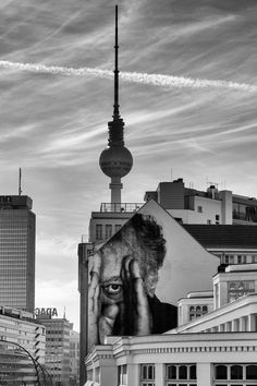 a black and white photo of a building with a painting on it's side