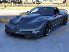 a gray sports car parked in a parking lot