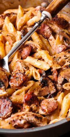 a skillet filled with pasta and sausage