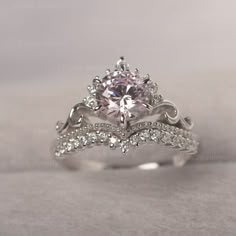 a white gold engagement ring with an oval center stone surrounded by round brilliant cut diamonds