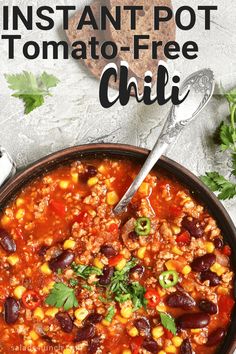 instant pot tomato - free chili in a bowl with a spoon and cilantro on the side