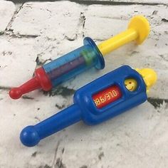 two plastic toys that look like they are in the shape of an hour and temperature gauge