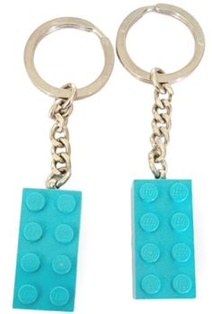 two lego key chains are attached to each other, one is blue and the other is green