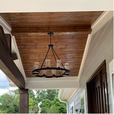 a chandelier hanging from the ceiling on a porch