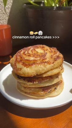 a stack of pancakes sitting on top of a white plate