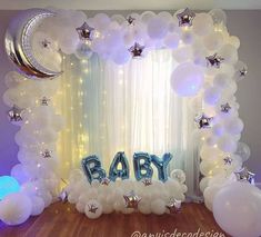 a baby shower is decorated with balloons and stars