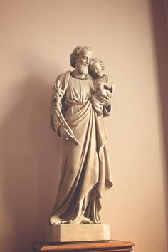 a statue of jesus holding a child in his arms