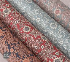 four different types of wallpaper on a wooden floor