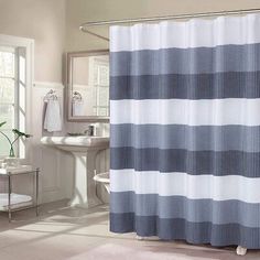 a white and blue shower curtain in a bathroom