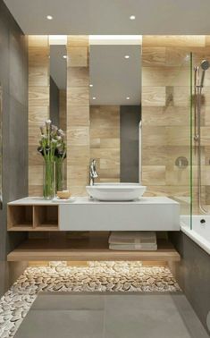 a bathroom with a sink, mirror and bathtub next to a shower stall filled with flowers