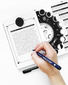 a person is writing on an open book with the moon phases in black and white