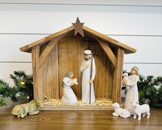 a wooden nativity scene with figurines and decorations