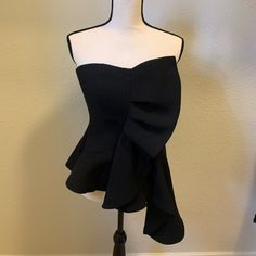 Mint Condition Black Strapless Top With Ruffle And Extended Asymmetrical Flare! Gorgeous With Jeans And A Night On The Town!! Never Worn Stretch Ruffle Tube Top For Party, Stretch Ruffled Tube Top For Party, Party Tube Top With Ruffles And Stretch, Black Bandeau Tube Top With Ruffles, One Shoulder Stretch Tube Top For Party, Spring Black Off-shoulder Tube Top, One Shoulder Tube Top For Date Night, Black Tube Top For Spring Party, Spring One Shoulder Tube Top For Night Out