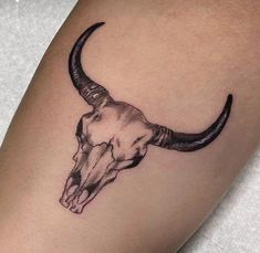 a bull's head tattoo on the right arm is shown in black and white