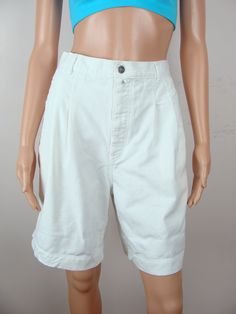 "Vintage Calvin Klein long white jean shorts from the 80s.  Features a 1.5\" waistband with 6 belt loops, a branded metal button and 7\" zipper fly front closure.  Has pleats in front and darts in back, 6\" front side welt style pockets and one 5\" welt style back pocket with branded metal button closure.  Has baggy, wide knee length legs.  Made of a white denim material.  Freshly laundered and ready to wear. Label: \"Blue Jeans Calvin Klein\". Fiber Content: 100% Cotton. Stamped size: 33.  Plea Calvin Klein High Waisted, Red Denim Shorts, Cutwork Top, Vintage Denim Shorts, Vintage Calvin Klein, White Jean Shorts, 90s Streetwear, Yellow Shorts, Jeans For Short Women