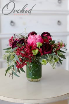 a vase filled with flowers sitting on top of a table