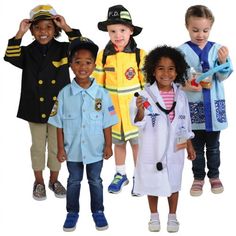 children in fireman's uniforms posing for the camera