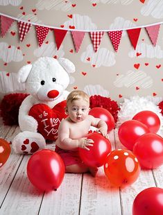 a baby sitting on the floor surrounded by balloons