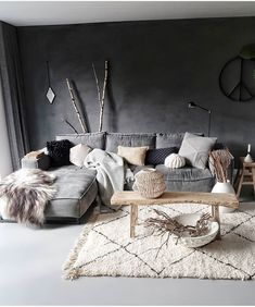 a living room filled with lots of furniture next to a wall mounted clock on the wall